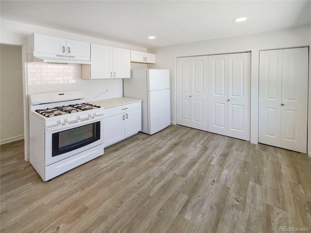 1298 S Seneca Way, Denver, CO 80223 - kitchen featuring white appliances, under cabinet range hood, white cabinetry, light wood-style floors, and light countertops
