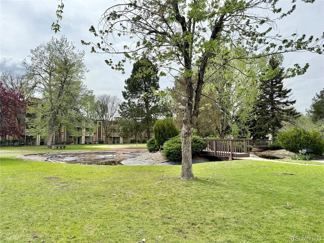view of grassy yard with a wooden deck