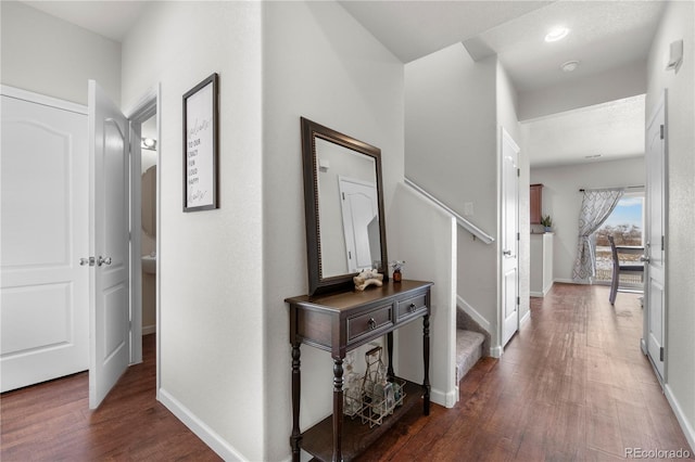 hallway with dark hardwood / wood-style flooring