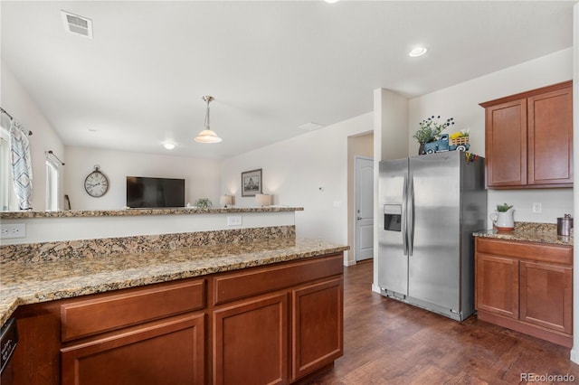 kitchen featuring dark hardwood / wood-style floors, dishwashing machine, hanging light fixtures, light stone counters, and stainless steel refrigerator with ice dispenser