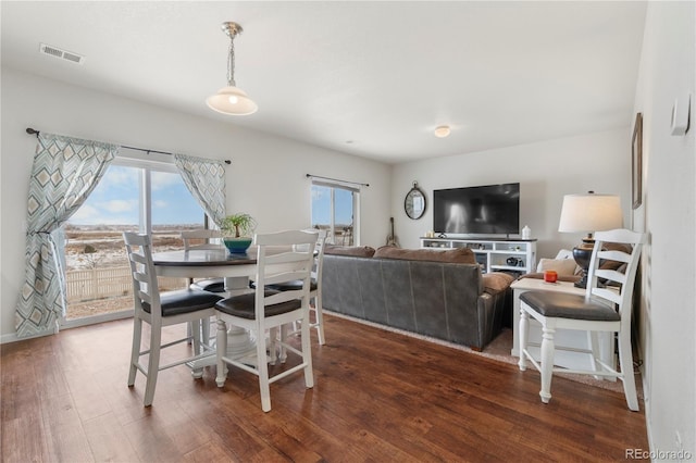 dining space with dark hardwood / wood-style floors