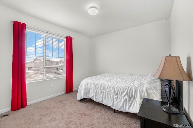 bedroom featuring light colored carpet