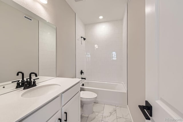 full bathroom with vanity, tiled shower / bath combo, and toilet