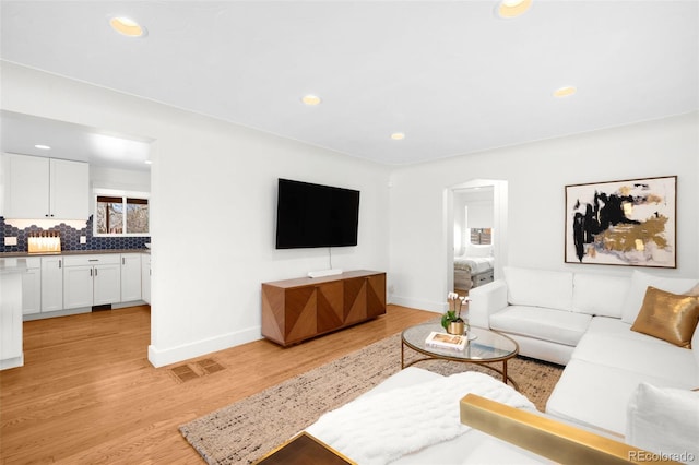3925 Newland St, Wheat Ridge, CO 80033 - living area with light wood-style floors, recessed lighting, and baseboards
