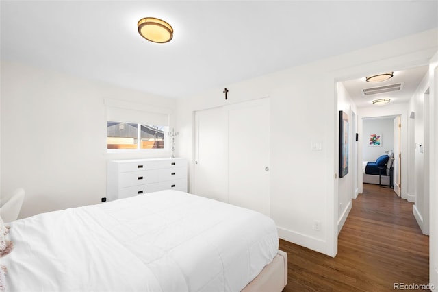 3925 Newland St, Wheat Ridge, CO 80033 - bedroom with wood finished floors, a closet, and baseboards