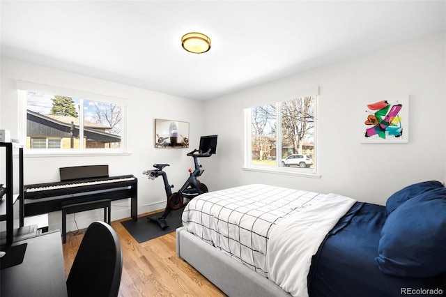3925 Newland St, Wheat Ridge, CO 80033 - bedroom featuring multiple windows, light wood-type flooring, and baseboards