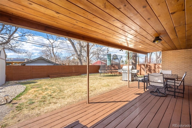 3925 Newland St, Wheat Ridge, CO 80033 - wooden terrace featuring outdoor dining area, a trampoline, and area for grilling