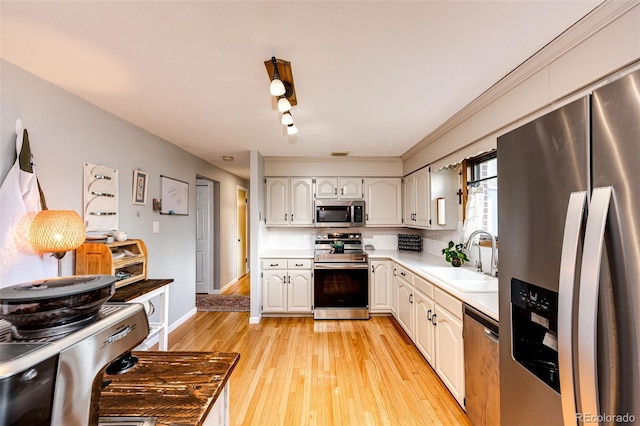 4645 W Temple Pl, Denver, CO 80236 - kitchen with stainless steel appliances, light wood-style flooring, light countertops, and white cabinets
