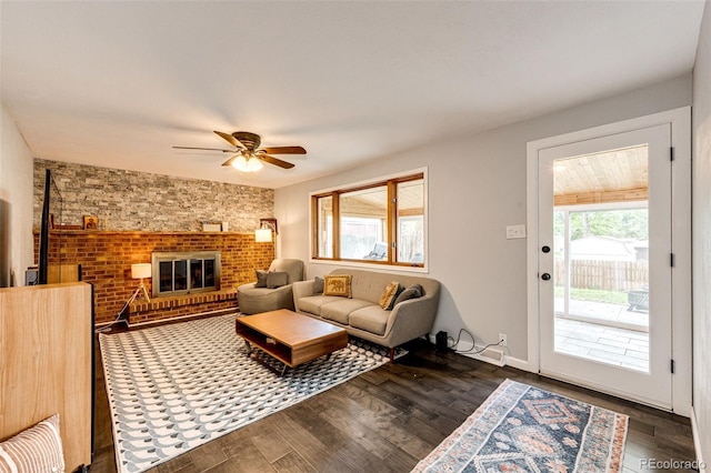 4645 W Temple Pl, Denver, CO 80236 - living area with a ceiling fan, dark wood-style flooring, a fireplace, and brick wall