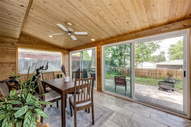 4645 W Temple Pl, Denver, CO 80236 - sunroom featuring an outdoor fire pit, a ceiling fan, wood ceiling, wooden walls, and lofted ceiling