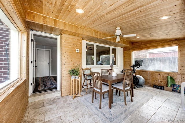 4645 W Temple Pl, Denver, CO 80236 - dining area featuring wood walls, ceiling fan, healthy amount of natural light, stone tile floors, and wooden ceiling