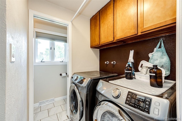 4645 W Temple Pl, Denver, CO 80236 - washroom featuring cabinet space, washing machine and clothes dryer, and light marble finish flooring