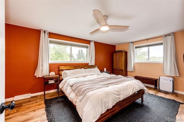 4645 W Temple Pl, Denver, CO 80236 - bedroom featuring multiple windows, wood finished floors, and a ceiling fan