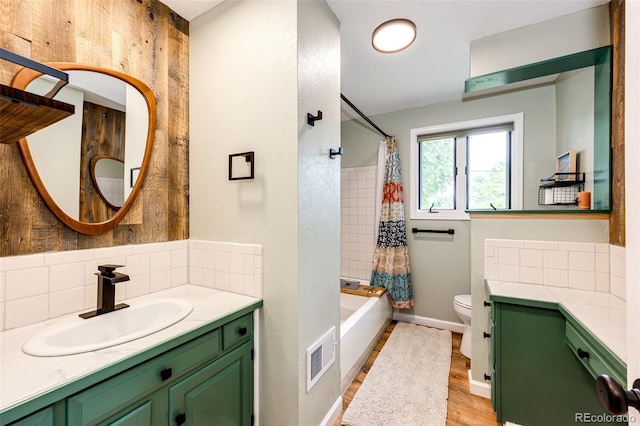 4645 W Temple Pl, Denver, CO 80236 - bathroom with vanity, tasteful backsplash, shower / tub combo, and wood finished floors