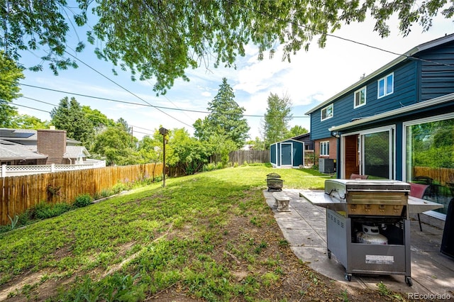 4645 W Temple Pl, Denver, CO 80236 - fenced backyard with a storage unit, an outdoor fire pit, and a patio area