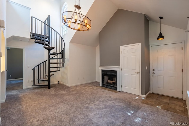 4943 S Carson St Unit 207, Aurora, CO 80015 - unfurnished living room with high vaulted ceiling, carpet floors, a chandelier, stairway, and a fireplace with flush hearth