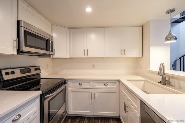4943 S Carson St Unit 207, Aurora, CO 80015 - kitchen featuring appliances with stainless steel finishes, white cabinets, light countertops, recessed lighting, and dark wood finished floors