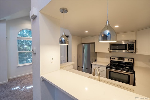 4943 S Carson St Unit 207, Aurora, CO 80015 - kitchen with appliances with stainless steel finishes, carpet flooring, pendant lighting, white cabinets, and recessed lighting