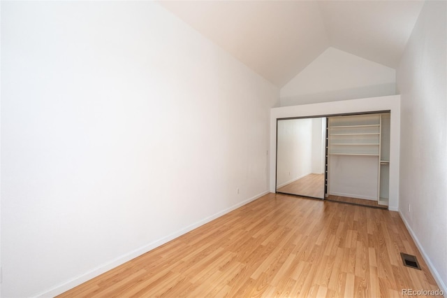 4943 S Carson St Unit 207, Aurora, CO 80015 - unfurnished bedroom with light wood finished floors, lofted ceiling, and a closet