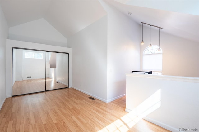 4943 S Carson St Unit 207, Aurora, CO 80015 - interior space featuring high vaulted ceiling, healthy amount of natural light, and light wood-type flooring