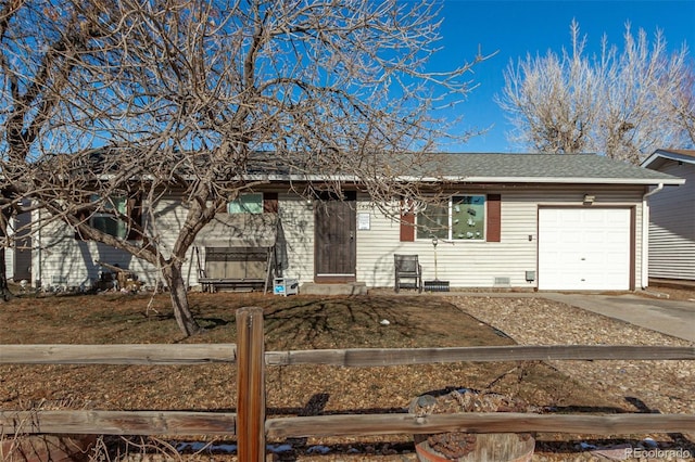 ranch-style house featuring concrete driveway, roof with shingles, and an attached garage