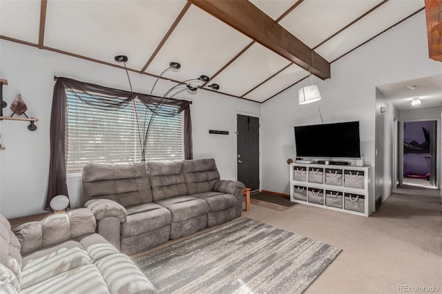 living area with carpet flooring and vaulted ceiling with beams