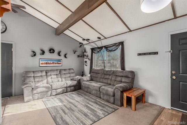 living area with lofted ceiling with beams and wood finished floors