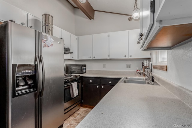 kitchen featuring black microwave, lofted ceiling with beams, a sink, stainless steel refrigerator with ice dispenser, and gas range oven