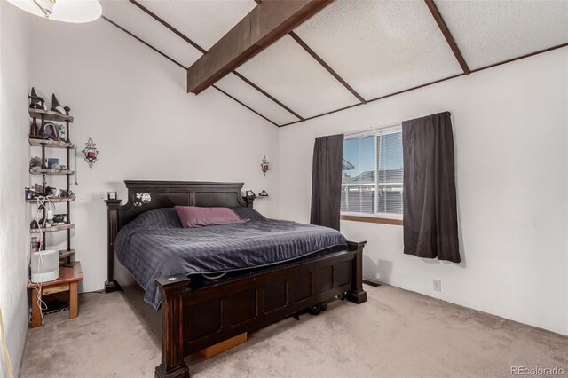 bedroom with vaulted ceiling with beams and carpet flooring