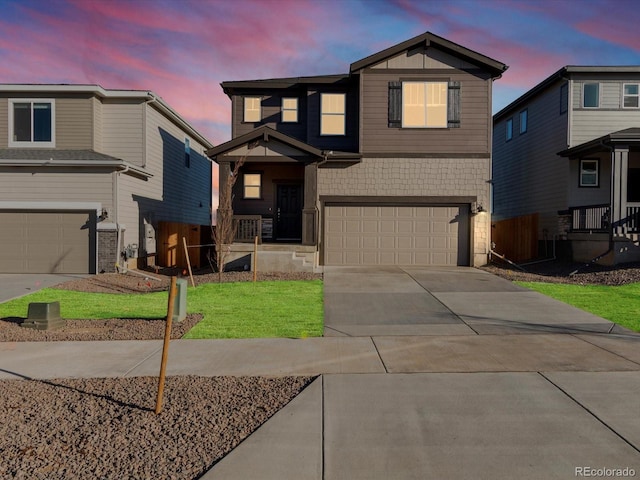 view of front of property featuring a yard and a garage