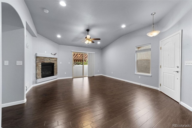 unfurnished living room with dark hardwood / wood-style flooring, ceiling fan, and vaulted ceiling