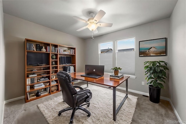 home office featuring a ceiling fan, baseboards, and carpet flooring