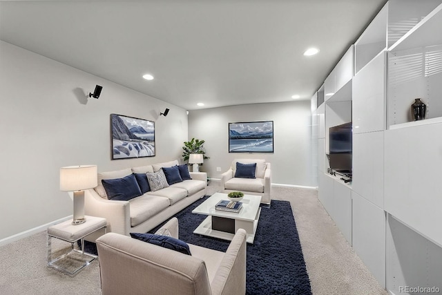 living area featuring recessed lighting, light carpet, and baseboards