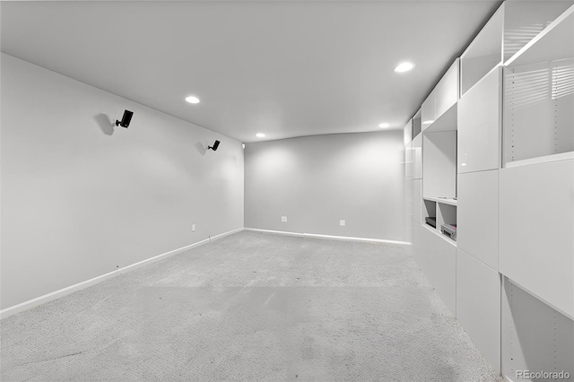 spare room with recessed lighting, light carpet, and baseboards