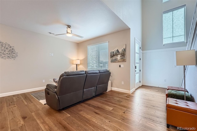 living room featuring hardwood / wood-style flooring and ceiling fan