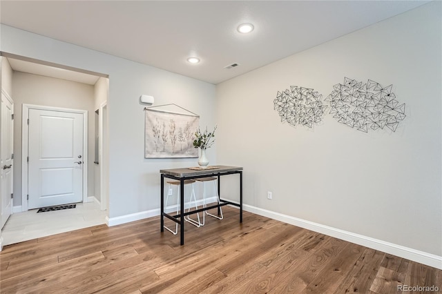 hallway with hardwood / wood-style flooring