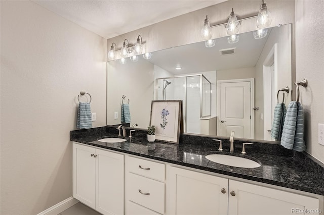 bathroom featuring vanity and an enclosed shower