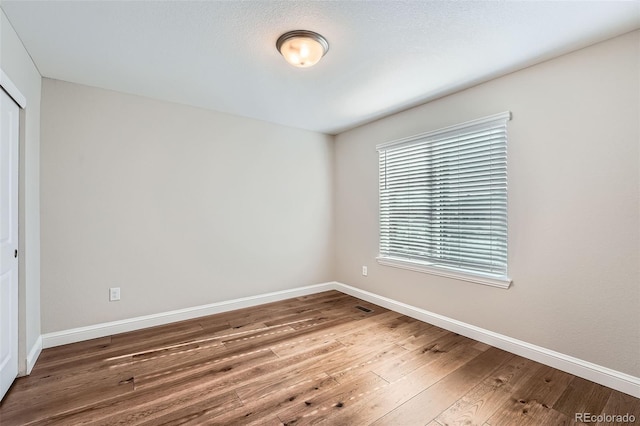 empty room featuring hardwood / wood-style flooring