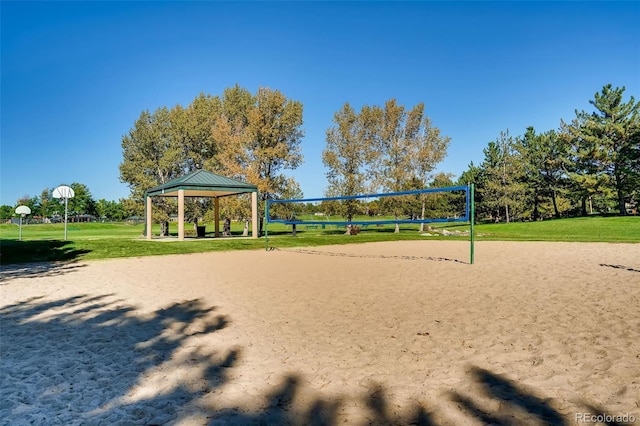 surrounding community featuring a gazebo, a lawn, and volleyball court