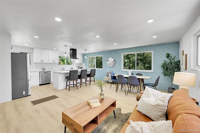 1173 Xenon St, Golden, CO 80401 - living room featuring a textured ceiling, light wood-style floors, and recessed lighting