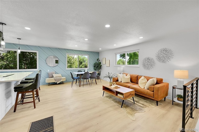 1173 Xenon St, Golden, CO 80401 - living area with a textured ceiling, recessed lighting, light wood-style floors, and baseboards