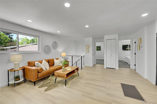 1173 Xenon St, Golden, CO 80401 - living room with light wood-type flooring, recessed lighting, and baseboards