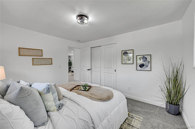 1173 Xenon St, Golden, CO 80401 - carpeted bedroom featuring a textured ceiling, baseboards, and a closet
