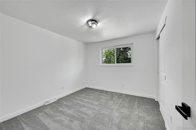 1173 Xenon St, Golden, CO 80401 - unfurnished bedroom with dark carpet, a textured ceiling, baseboards, and a closet