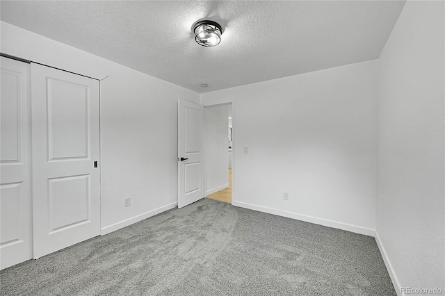 1173 Xenon St, Golden, CO 80401 - unfurnished bedroom featuring a textured ceiling, carpet floors, baseboards, and a closet