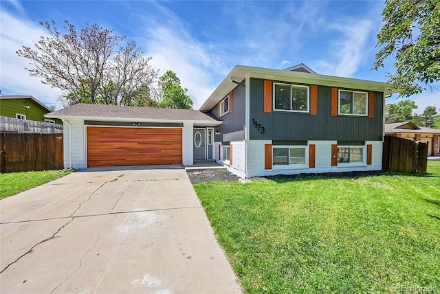 1173 Xenon St, Golden, CO 80401 - tri-level home featuring brick siding, a garage, and concrete driveway
