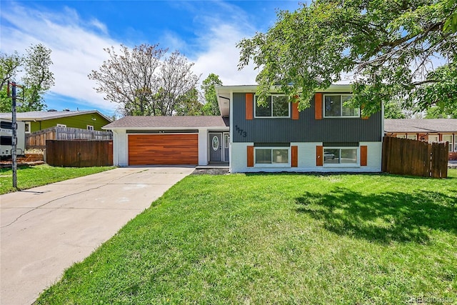 1173 Xenon St, Golden, CO 80401 - tri-level home featuring an attached garage and driveway