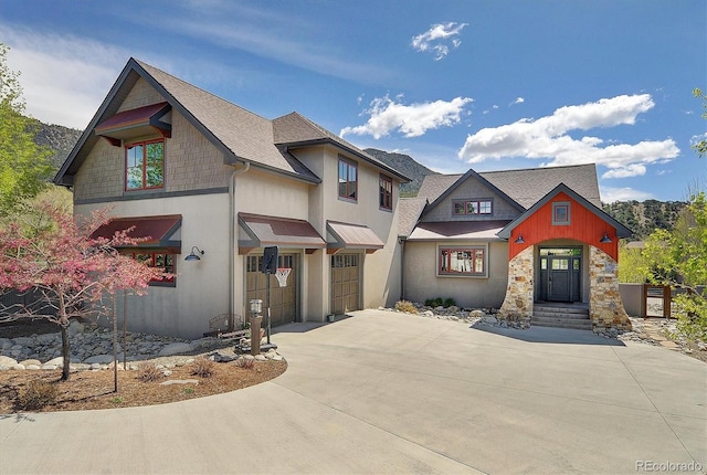 117 River Run Ct, Buena Vista, CO 81211 - craftsman house with a garage, driveway, a shingled roof, and stone siding