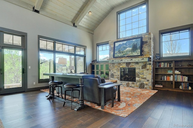 117 River Run Ct, Buena Vista, CO 81211 - living room featuring high vaulted ceiling, dark wood-style flooring, a stone fireplace, plenty of natural light, and wood ceiling with exposed beams