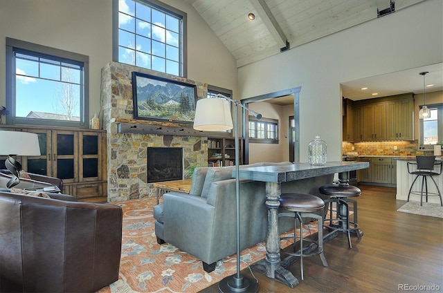 117 River Run Ct, Buena Vista, CO 81211 - living area featuring dark wood-type flooring, high vaulted ceiling, a fireplace, and beamed ceiling